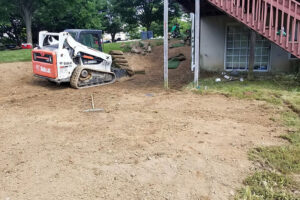 Skid steer grading backyard landscape project