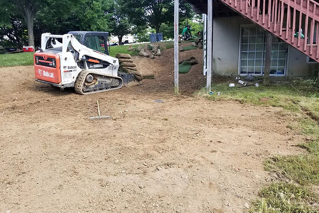 Skid steer grading backyard landscape project
